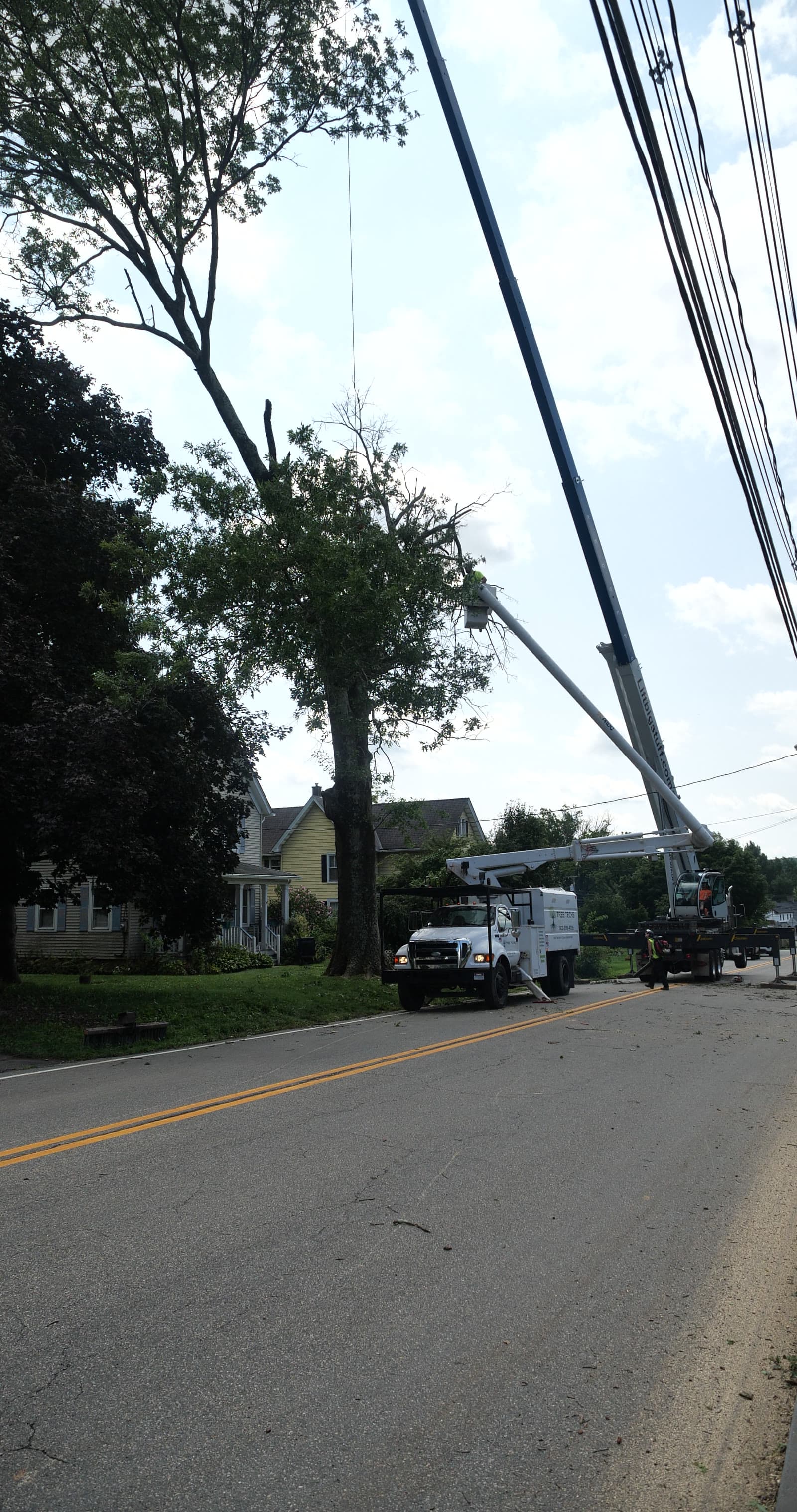 Crane lowering a large section near power lines